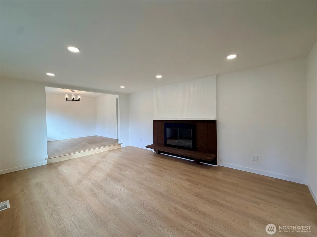 Spacious living room with fireplace and dining area