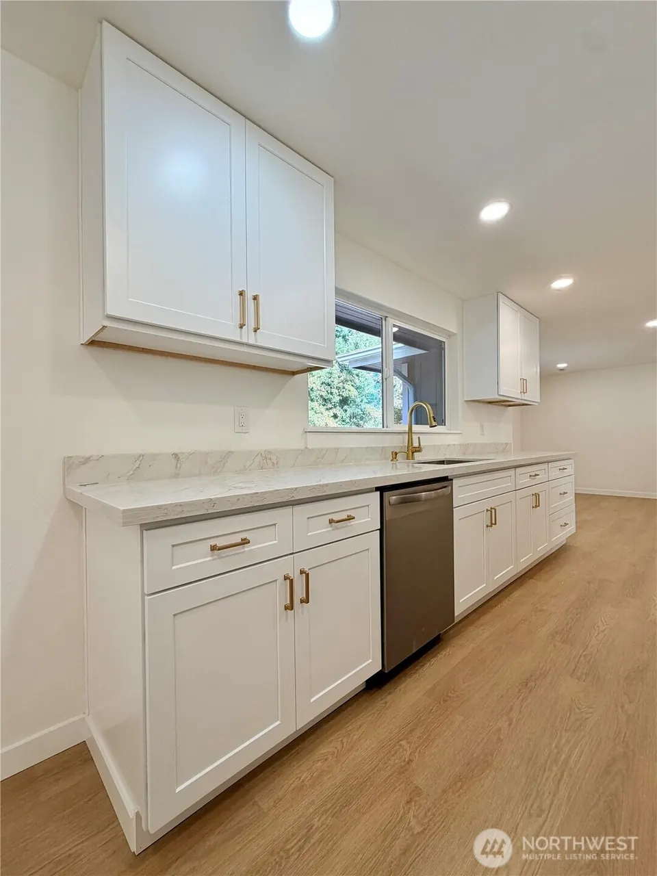 Modern kitchen with white cabinets and quartz countertops
